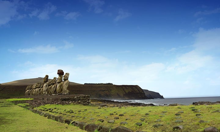 Moai statues on the grassy slopes of Easter Island near Nayara Hangaroa