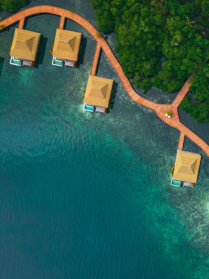 Aerial view of overwater villas on stilts above the mangroves at Nayara Bocas del Toro