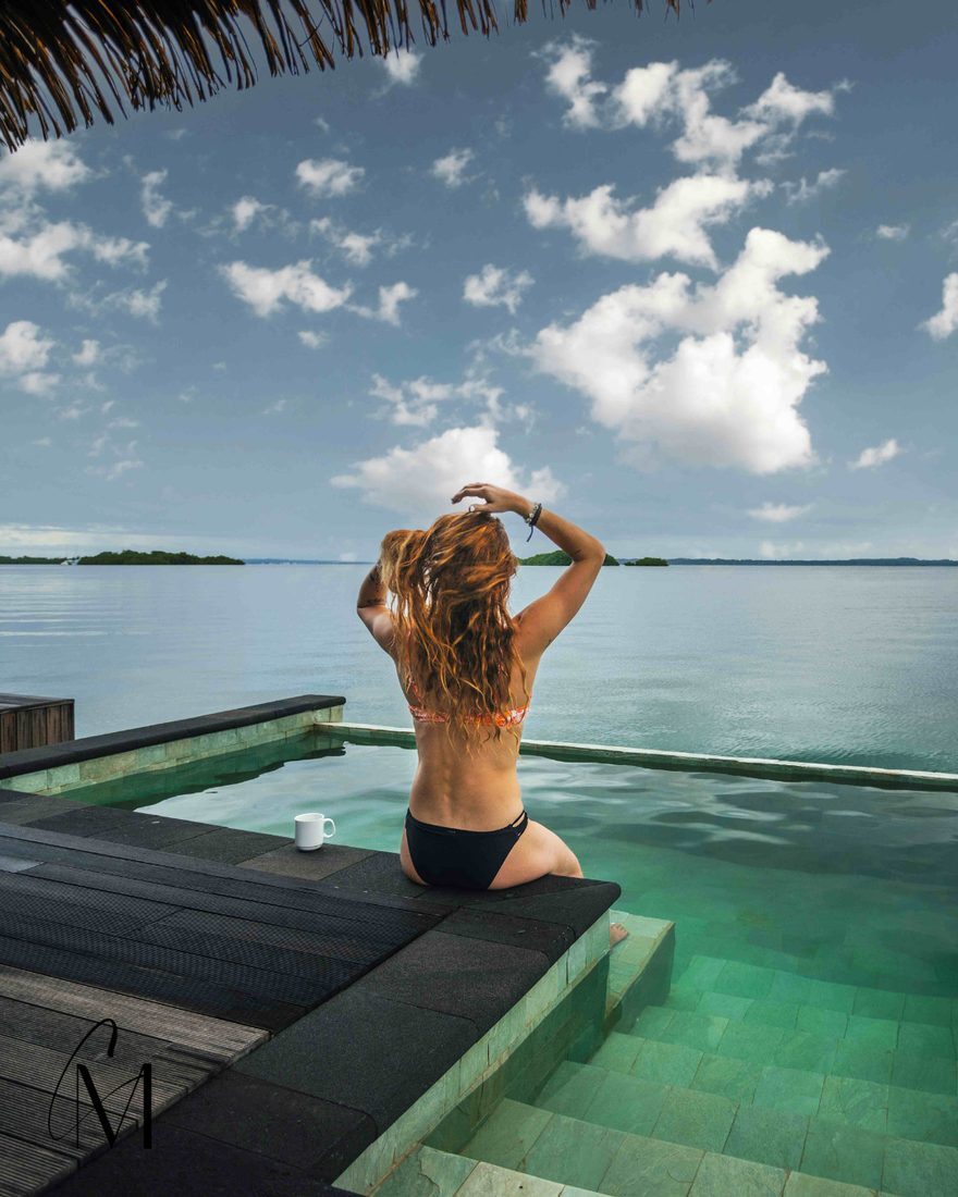 A guest at an infinity pool overlooking the Caribbean at Nayara Bocas del Toro